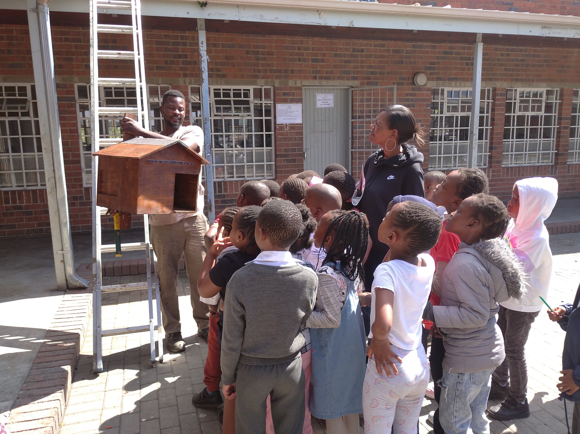 Respect Mabaso showing kids the owl box.jpg