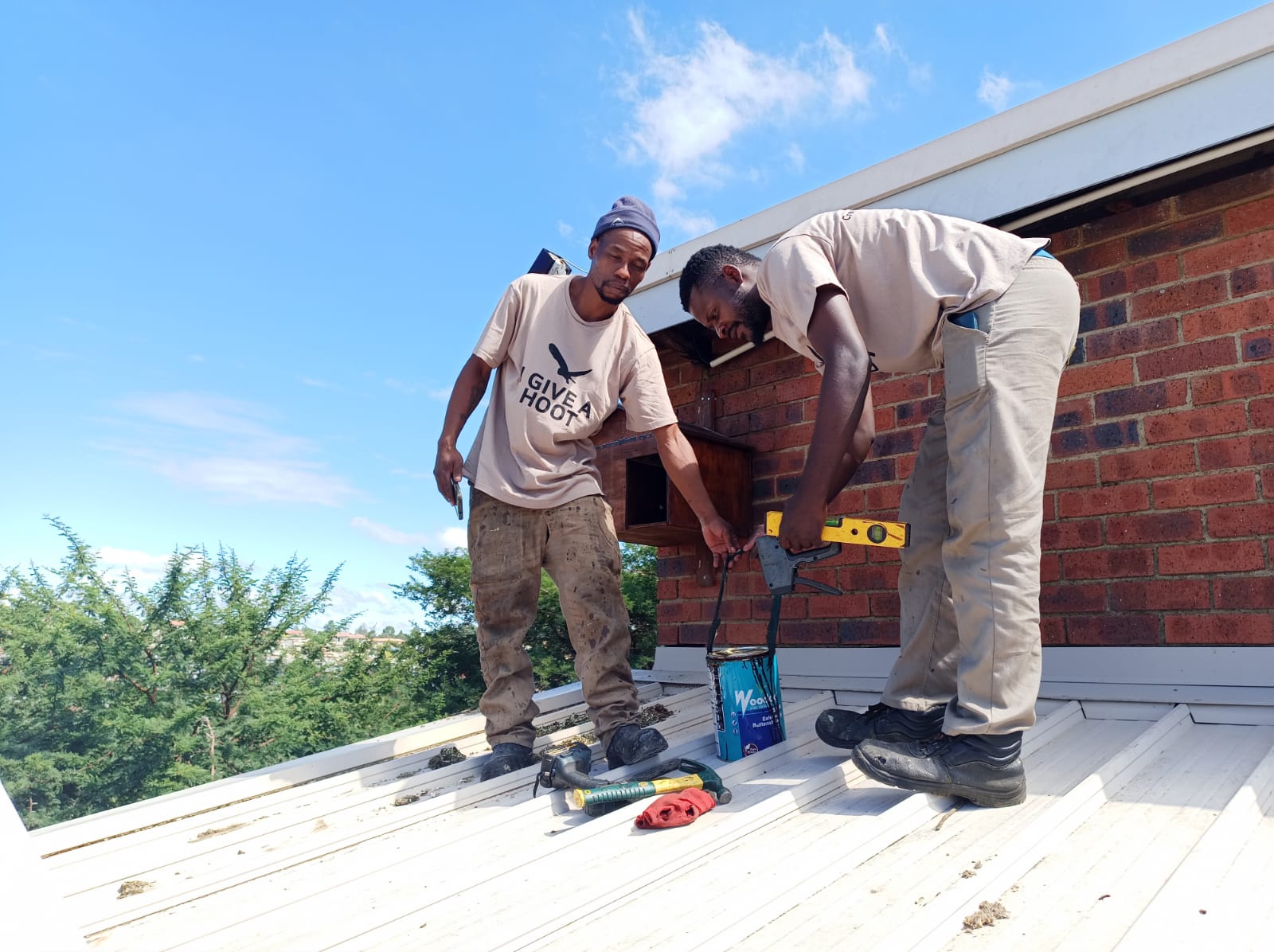 Thuso Thaba and Respect Mabaso - servicing owl box.jpeg